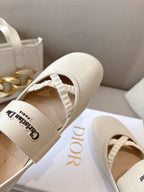 Back view of light cream Dior ballerina flats with cushioned heel and logo patch