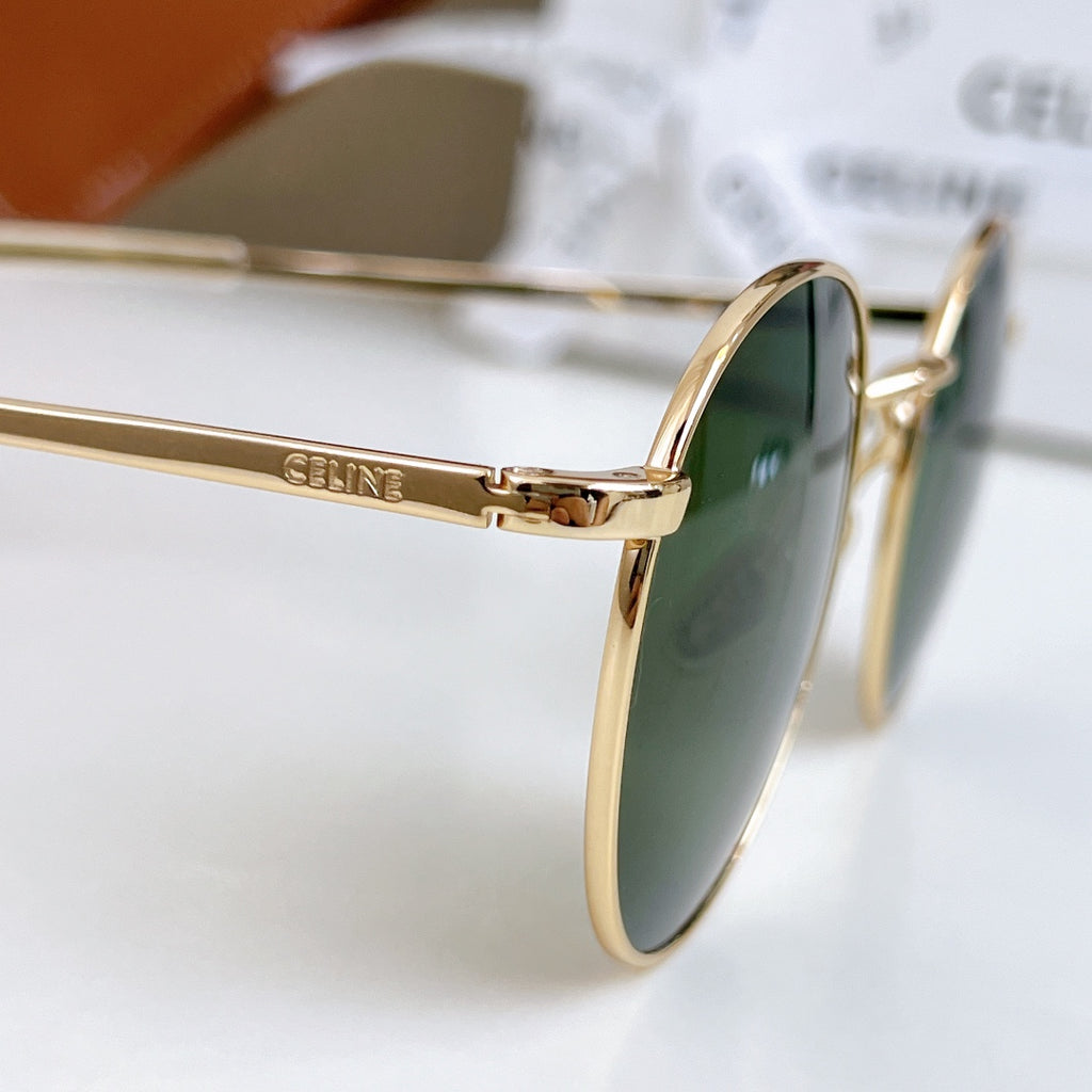 Gold sunglasses with green tinted lens, close side profile