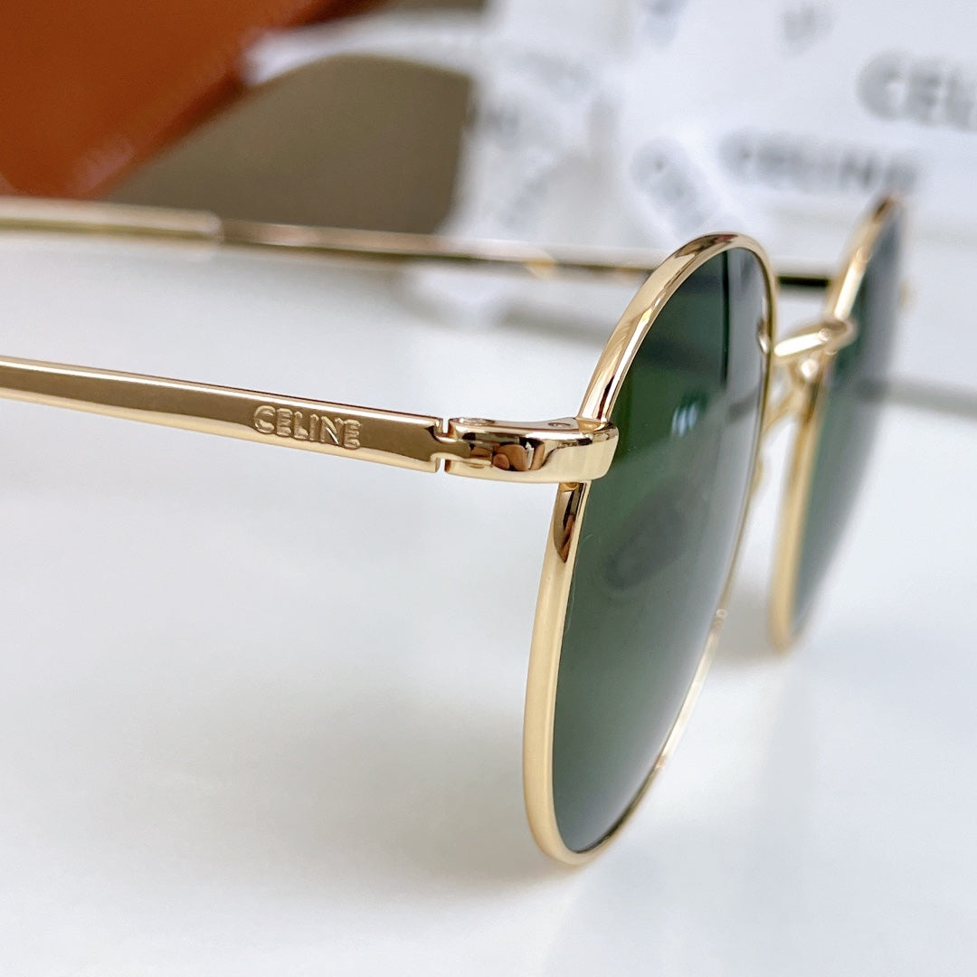 Gold sunglasses with green tinted lens, close side profile
