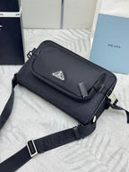 Prada small crossbody bag, black with front logo patch and adjustable shoulder strap