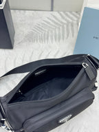 Prada crossbody bag open top view, black interior and zippered pocket