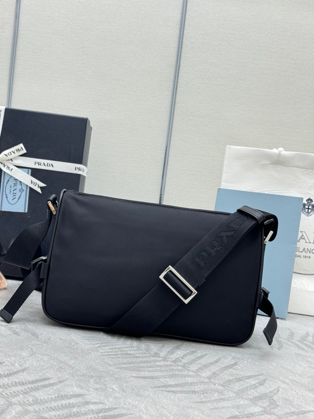 Prada crossbody bag, black front flap with square buckle and logo strap detail