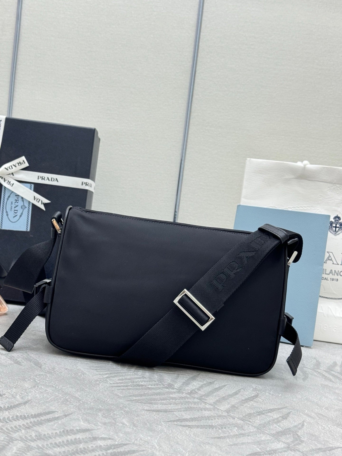 Prada crossbody bag, black front flap with square buckle and logo strap detail