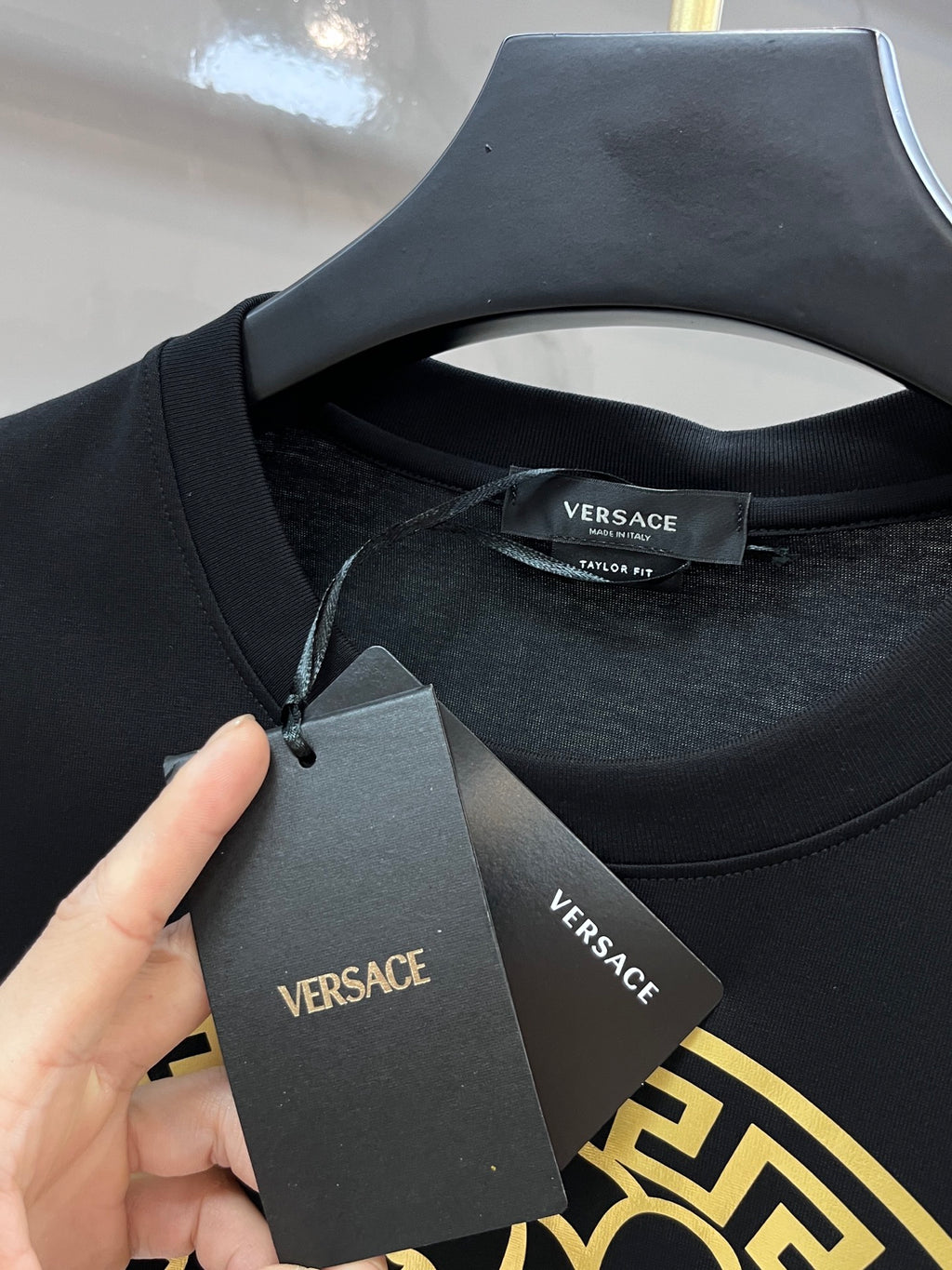 Versace black T-shirt neckline with hang tag and interior VERSACE label