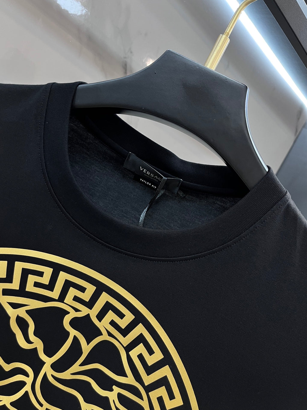 Versace black T-shirt collar close-up with neck label