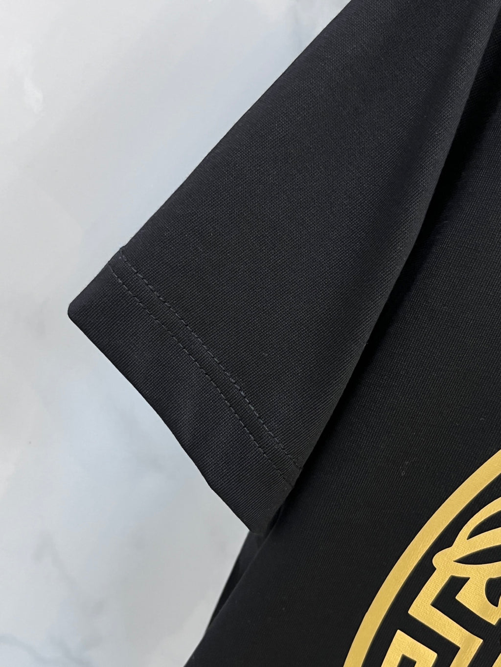 Black Versace T-shirt sleeve with stitched hem detail