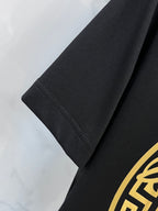 Versace black T-shirt sleeve hem detail with gold logo edge