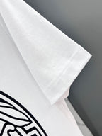 Versace white T-shirt sleeve close-up with black graphic partly visible
