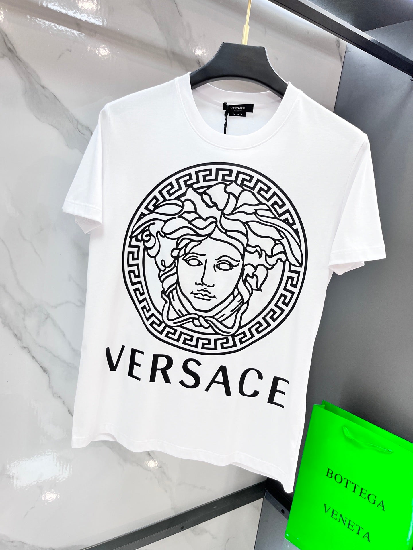 White Versace T-shirt with circular Medusa emblem and VERSACE text