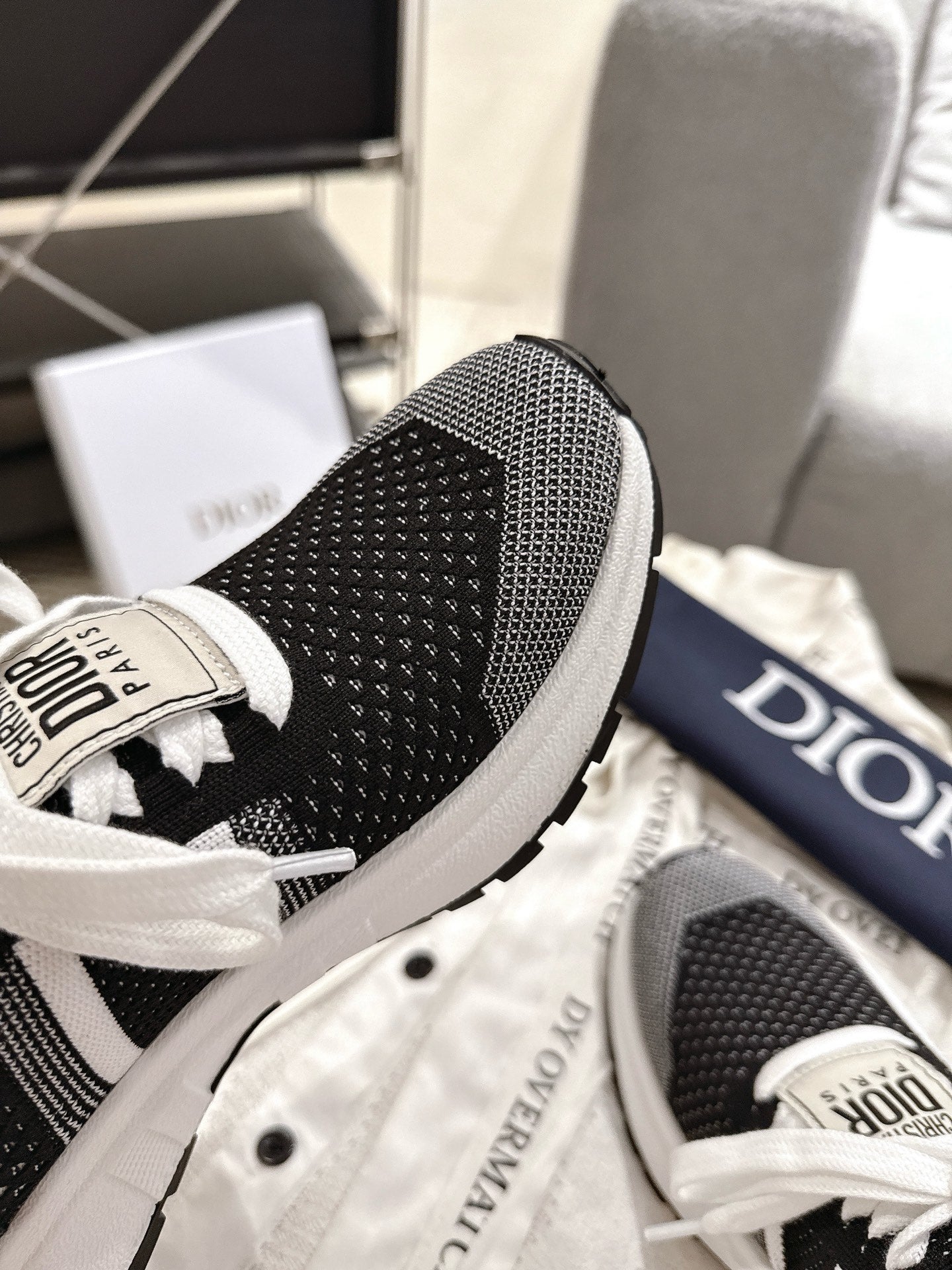 Unisex Dior sneaker heel, black mesh fabric with white midsole edge