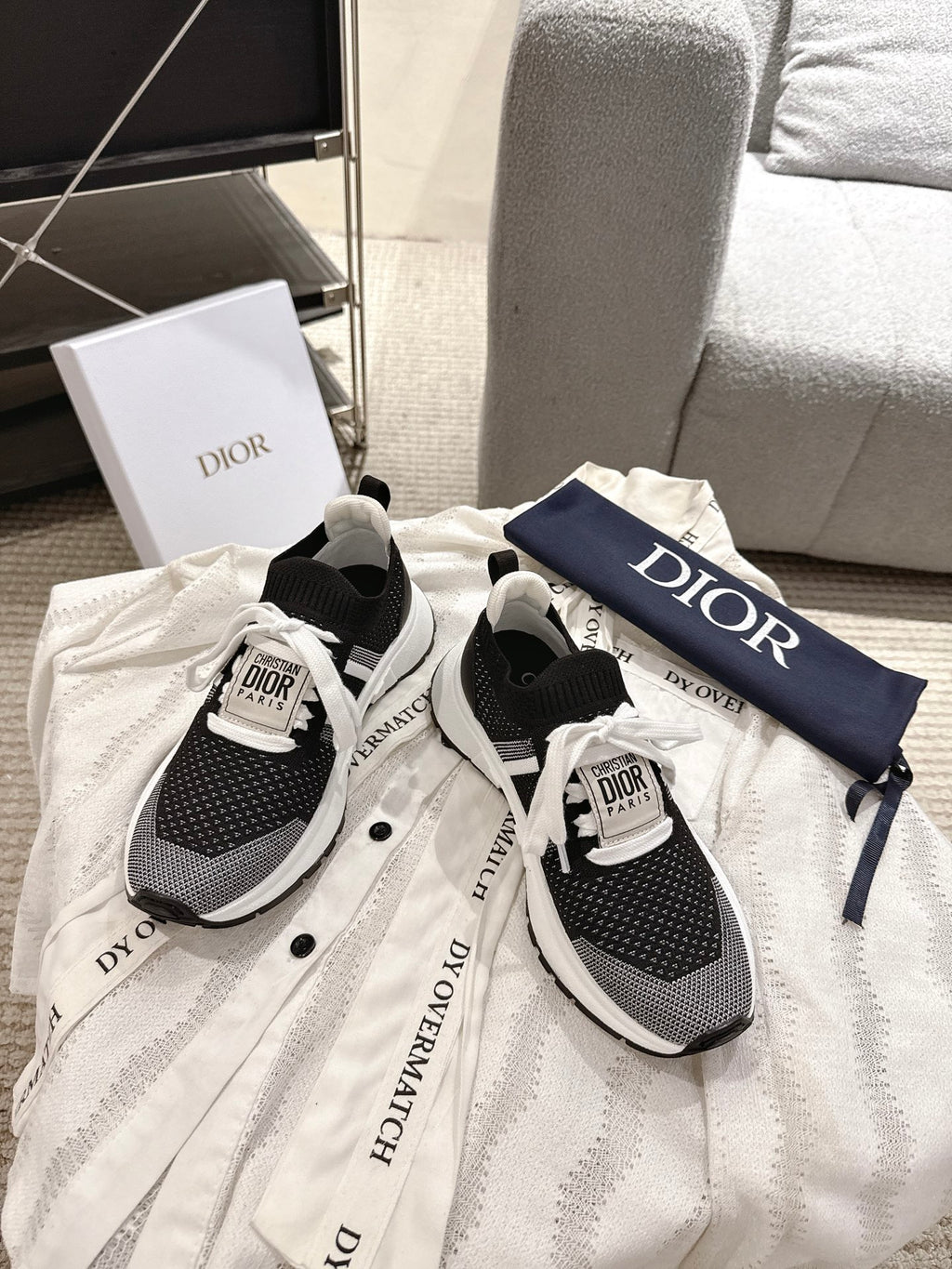 Unisex Dior sneakers pair, black and white design with logo tongue label