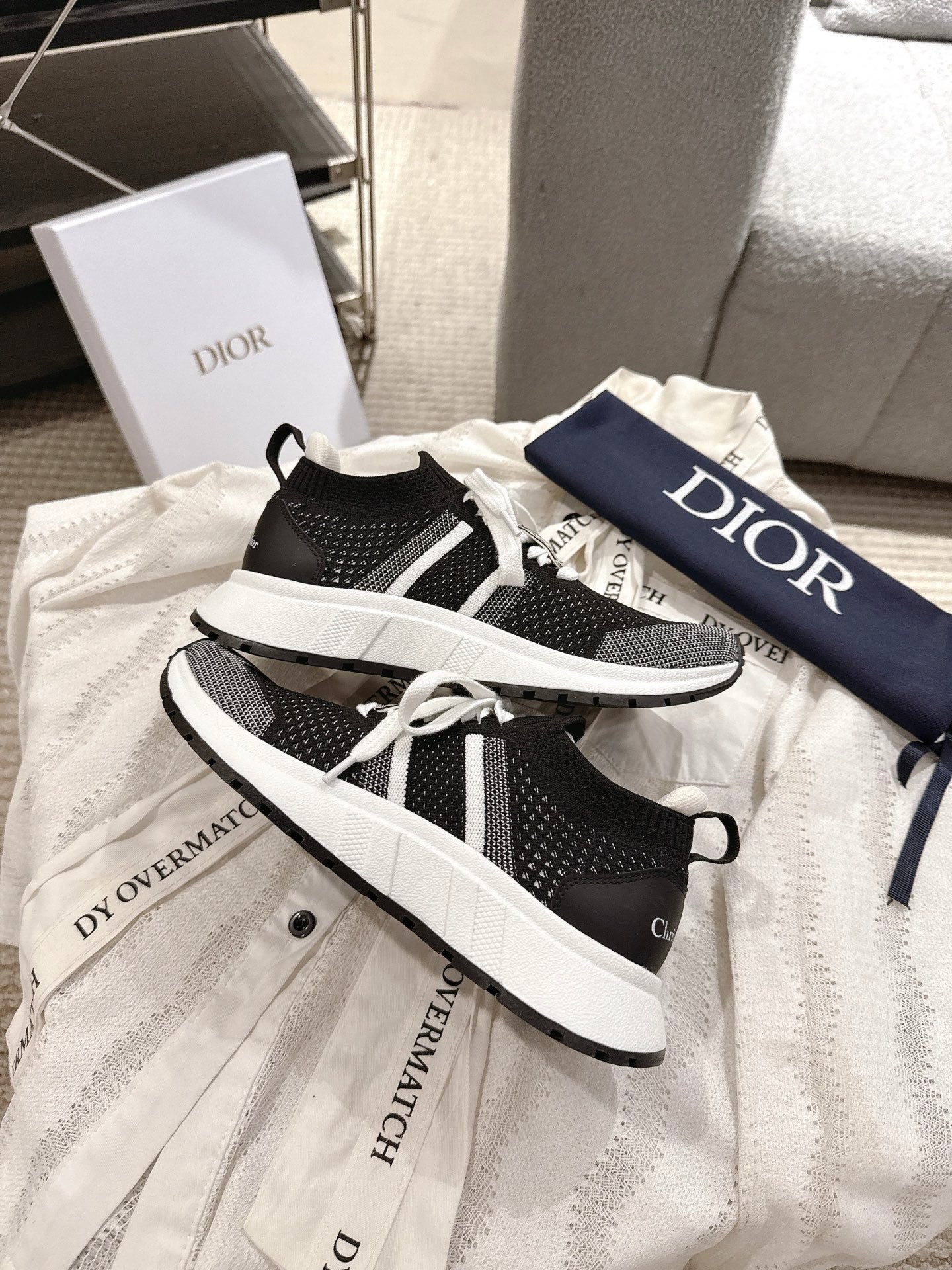 Unisex Dior sneakers, side view with black mesh panels and white midsole