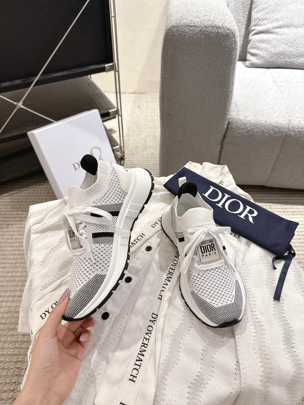 White mesh lace-up sneakers with black details and Dior logo on heel tab, pair