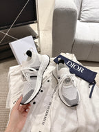 White mesh lace-up sneakers with black details and Dior logo on heel tab, pair