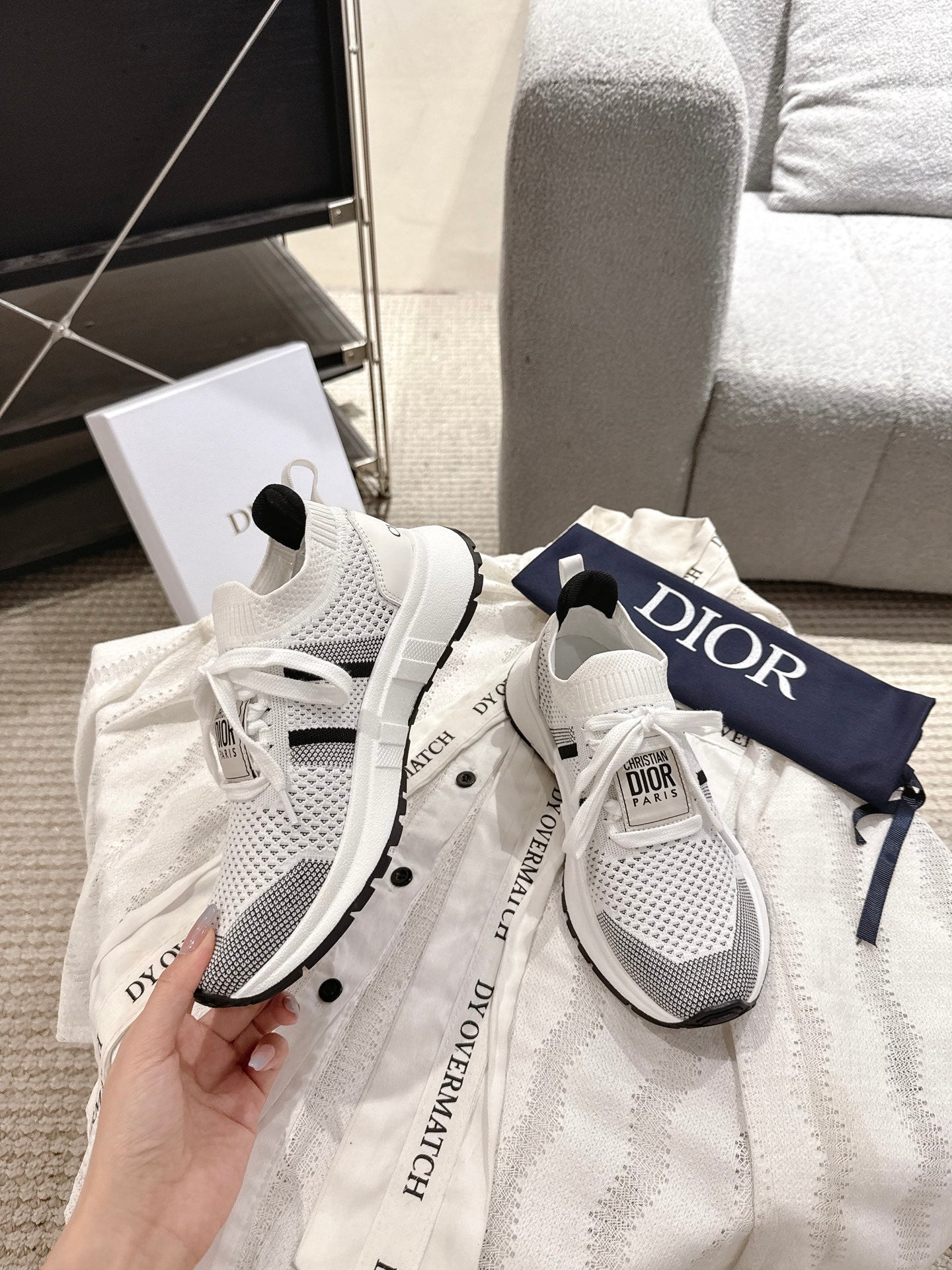 White mesh lace-up sneakers with black details and Dior logo on heel tab, pair