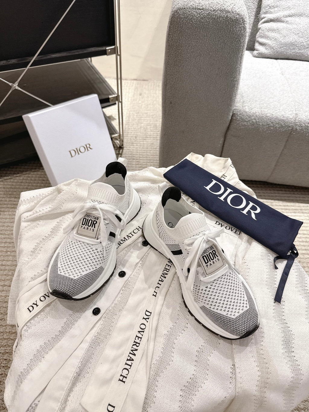 White mesh lace-up sneakers with black heel stripe and Dior logo on navy strap