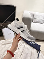 White mesh lace-up sneaker with black stripe and Dior logo on navy bag