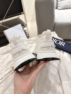 Dior unisex white sneakers, close-up of heel branding and black sole edge