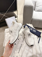 Dior unisex white sneakers, hand-held pair with lace-up knit and black sole trim