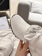 Dior unisex white sneaker, close-up of mesh heel and cushioned knit upper