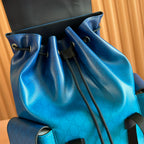 Blue Gucci backpack bag with drawstring top, metal eyelets, and gathered fabric.