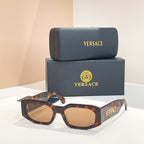 Tortoiseshell sunglasses with amber lenses and VERSACE logo on the temple arms