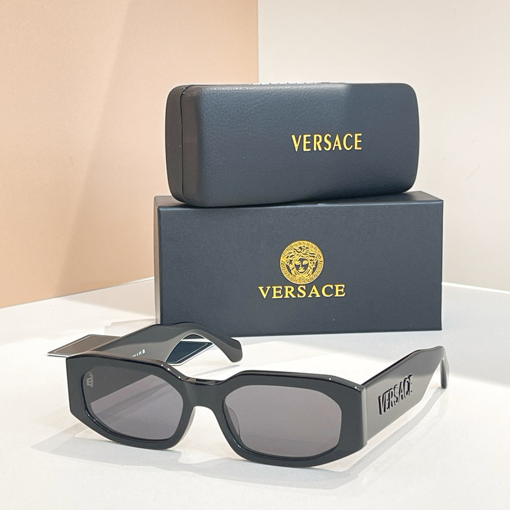 Black sunglasses with dark lenses and VERSACE branding on the temple arms