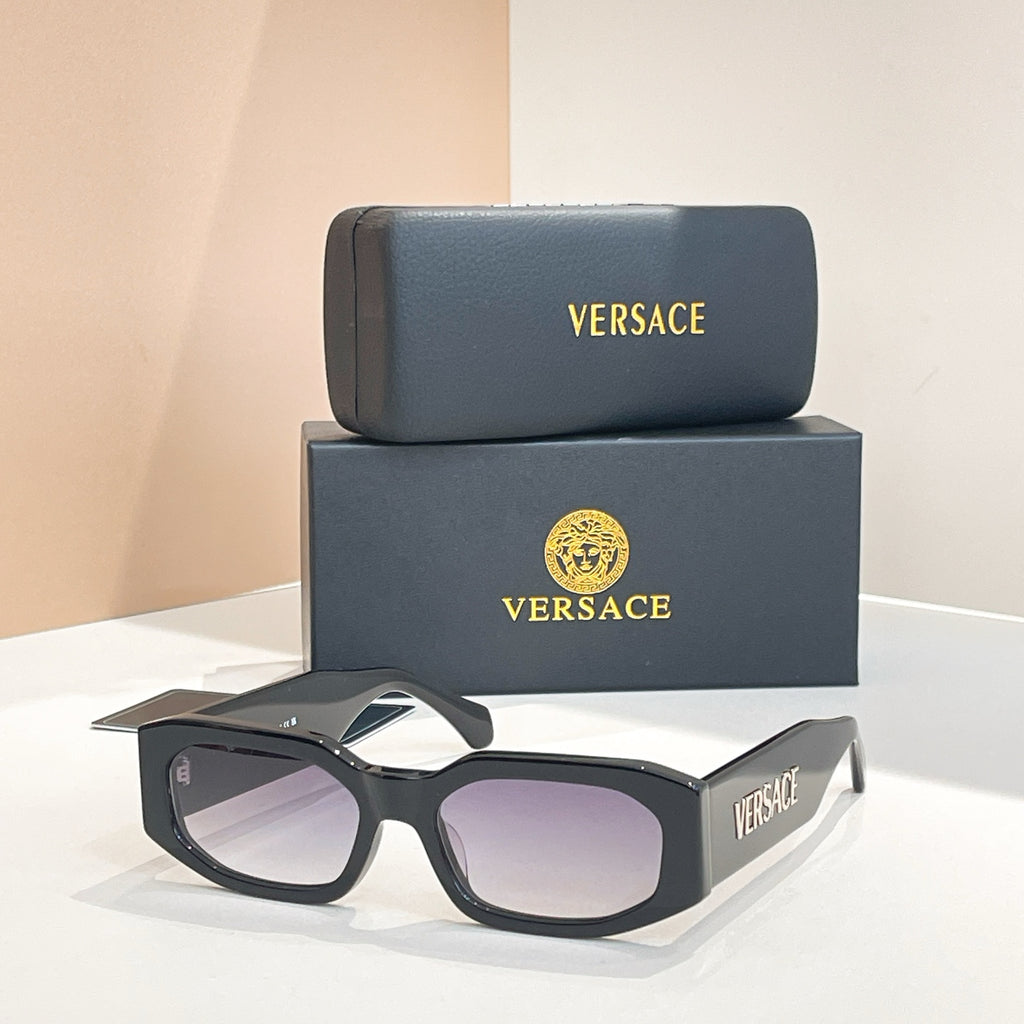 Black sunglasses with dark lenses, VERSACE logo on temple arms