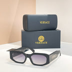 Black sunglasses with dark lenses, VERSACE logo on temple arms