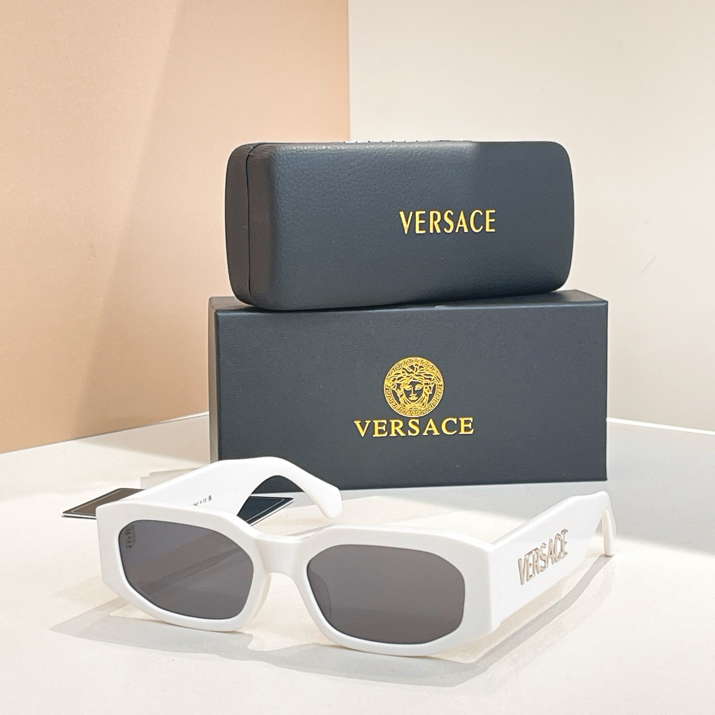 White acetate sunglasses with gray lenses and VERSACE logo on the temples