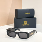 Black acetate sunglasses with dark lenses and VERSACE logo on the temples