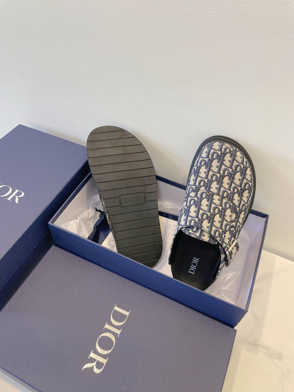 Monogram slide sandals with textured rubber sole and blue patterned upper