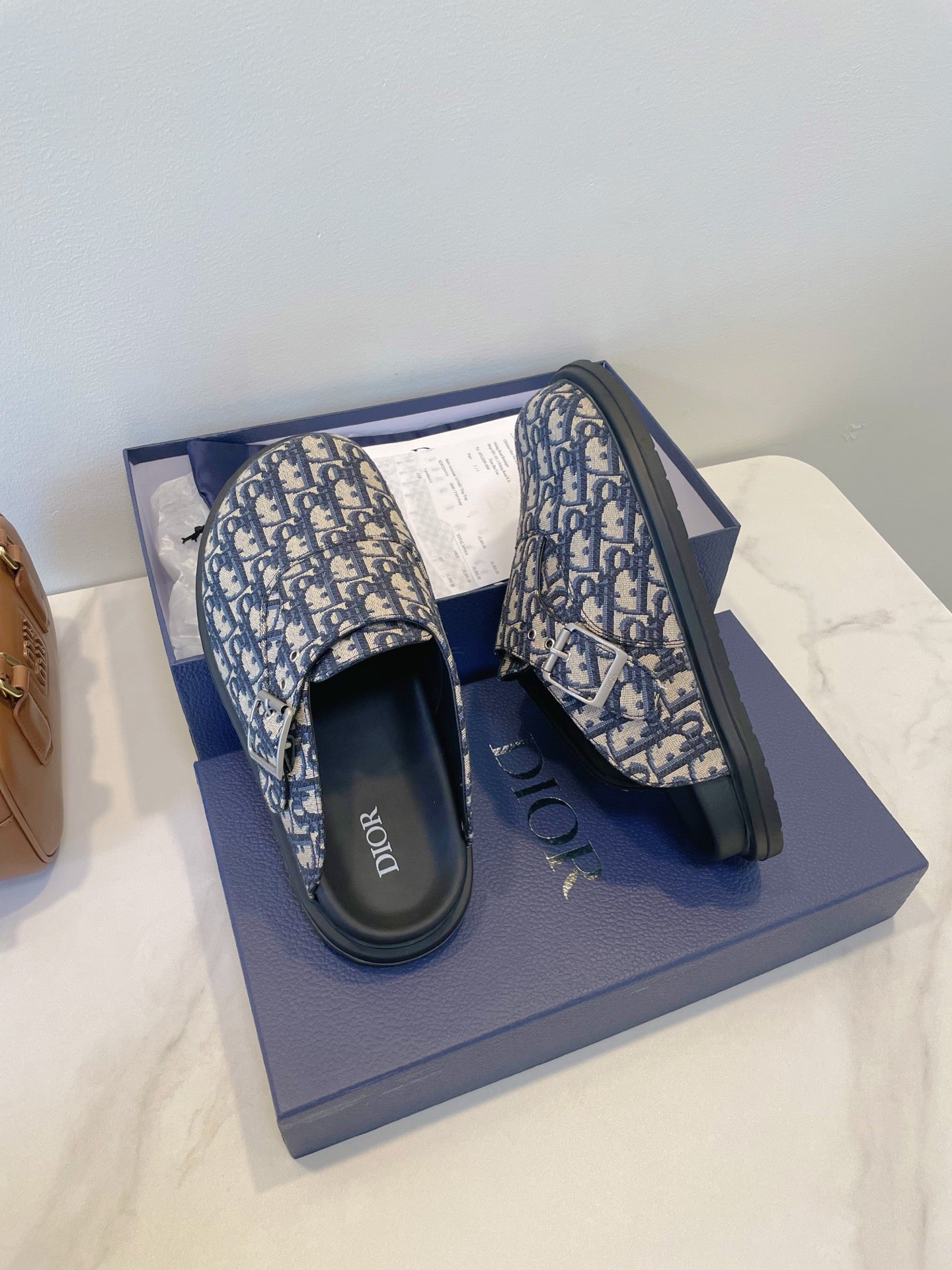 Monogram slip-on slide sandals with adjustable strap, blue-and-cream patterned upper
