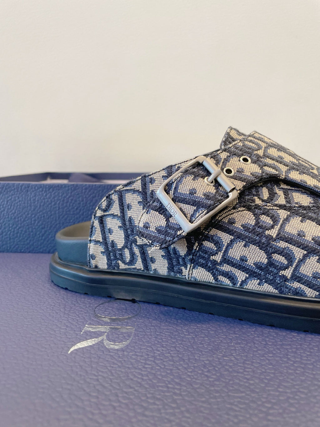 Monogram buckle slide sandals with blue patterned upper and rubber sole