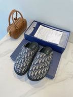 Monogram slide sandals with blue patterned upper and dark rubber sole