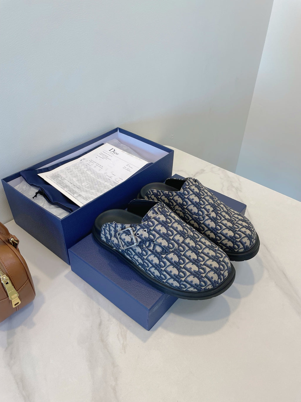 Monogram slip-on sandals with blue patterned upper and dark rubber sole