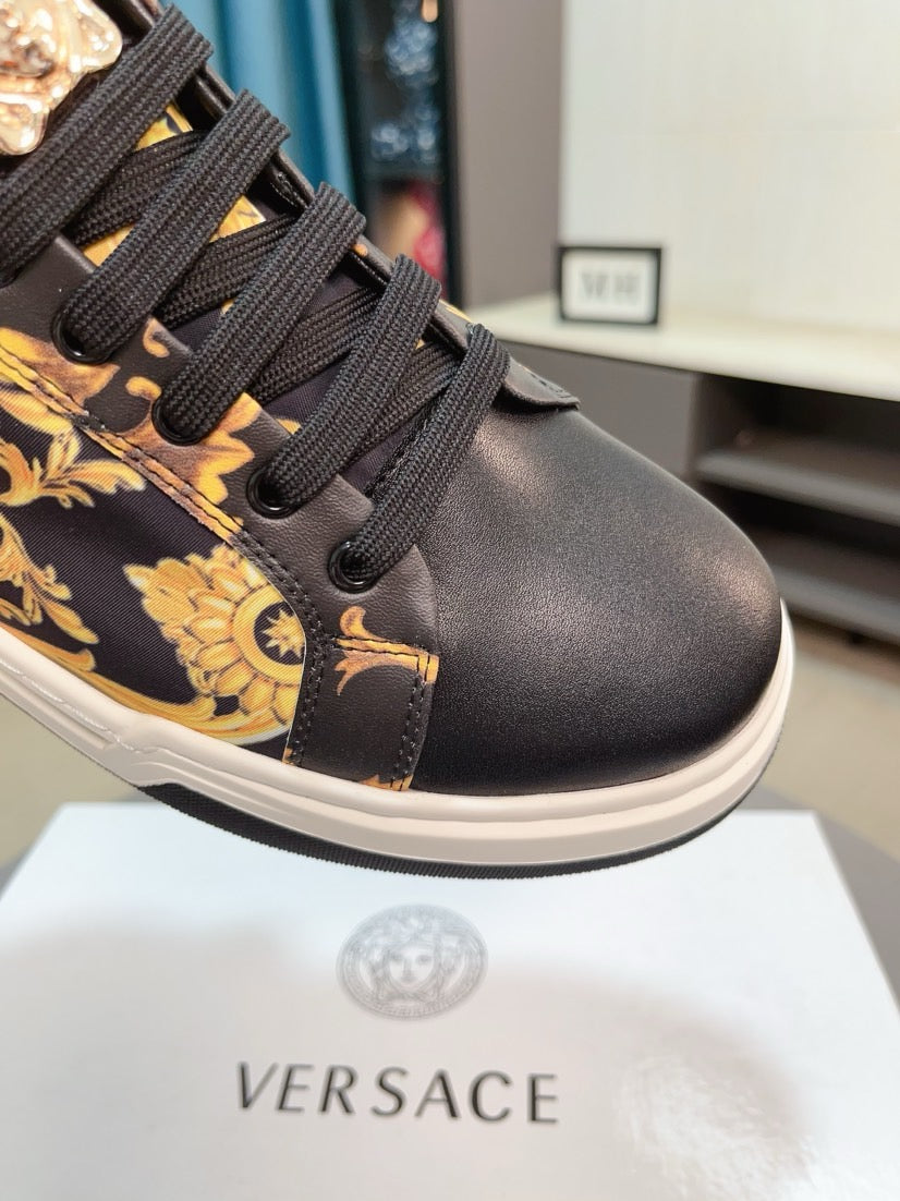 Versace sneakers close-up, dark leather toe and laces with gold baroque details