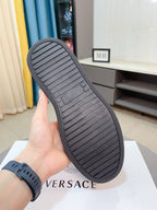 Versace sneakers outsole view, black rubber tread on white sidewall