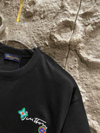 Black T-shirt chest with small flower and crest embroidery