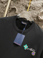 Black T-shirt neckline with embroidered logo patch and Louis Vuitton tag