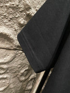 Black T-shirt with visible side seam and short sleeve hem