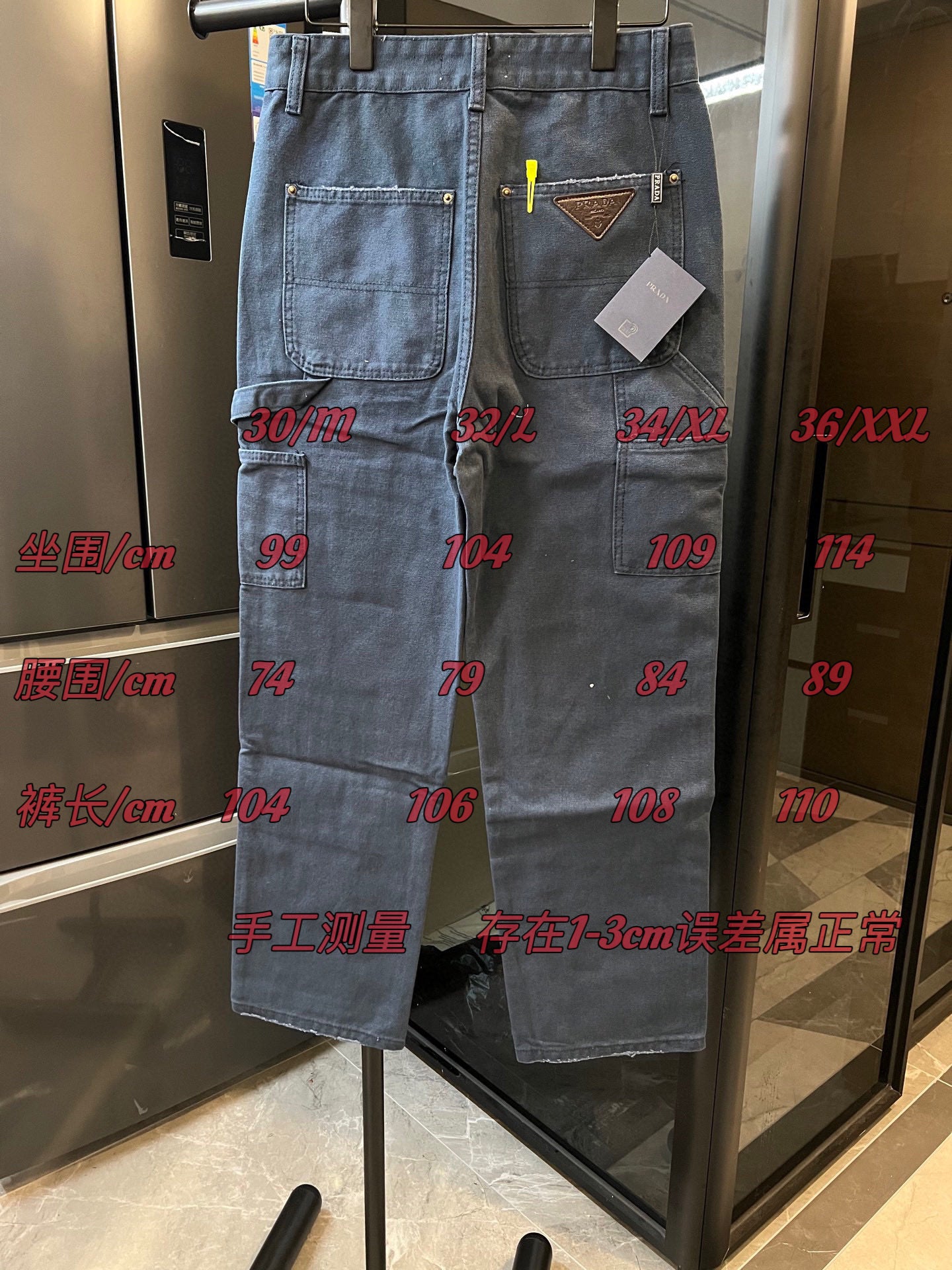 Prada denim cargo pants, light blue wash, with size markings overlaid on the garment