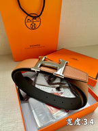 Leather belt with brown and dark straps and silver-tone H buckle, with papers in box.