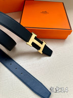Dark blue leather belt with silver H buckle detail and punched strap holes