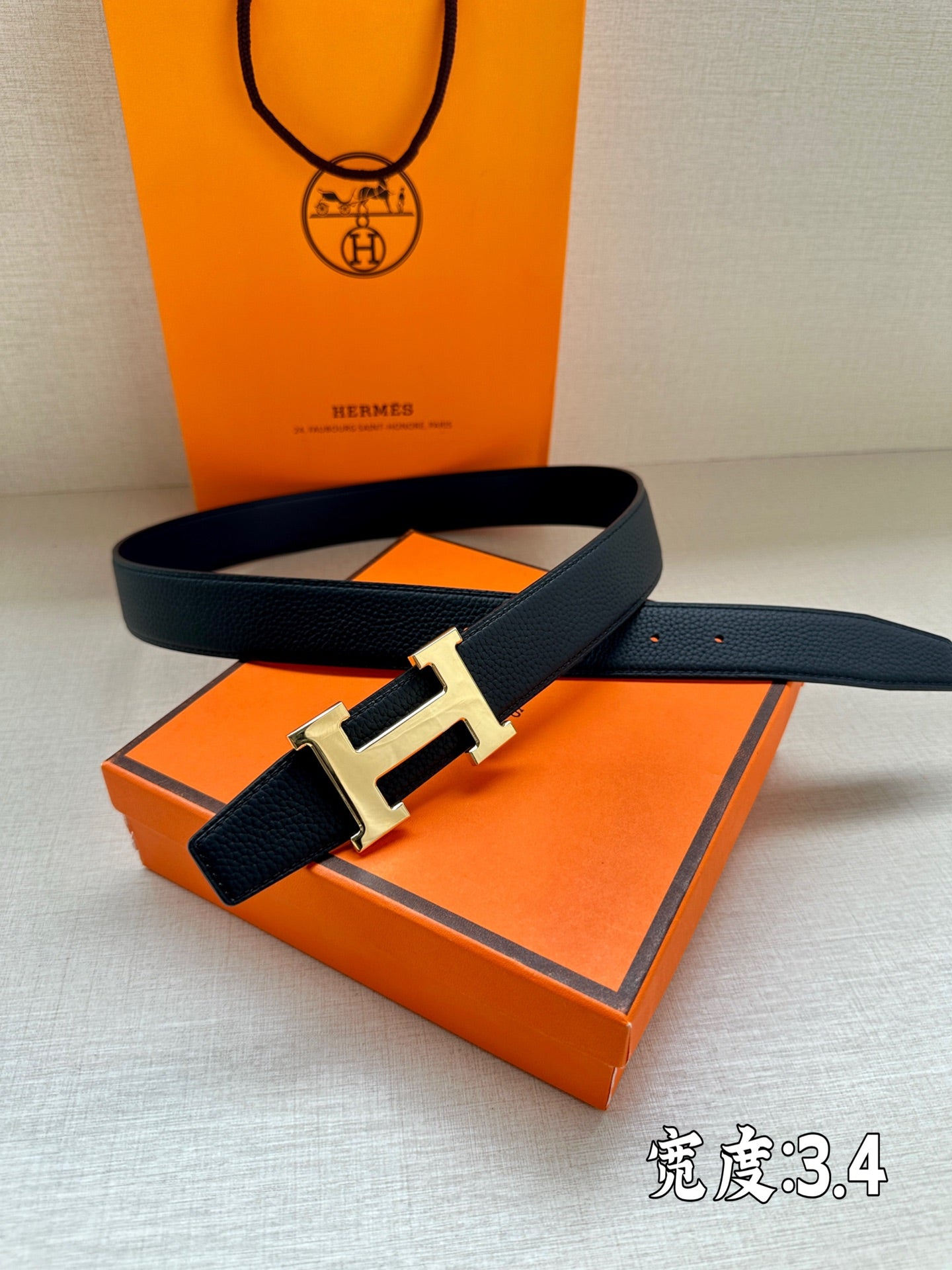 Dark blue leather belt with silver buckle over dark blue leather strap end