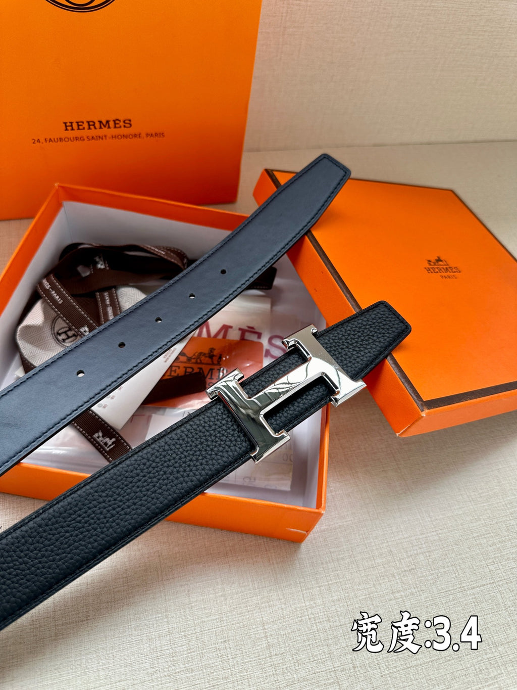 Dark blue leather belt with silver buckle and multiple punch holes