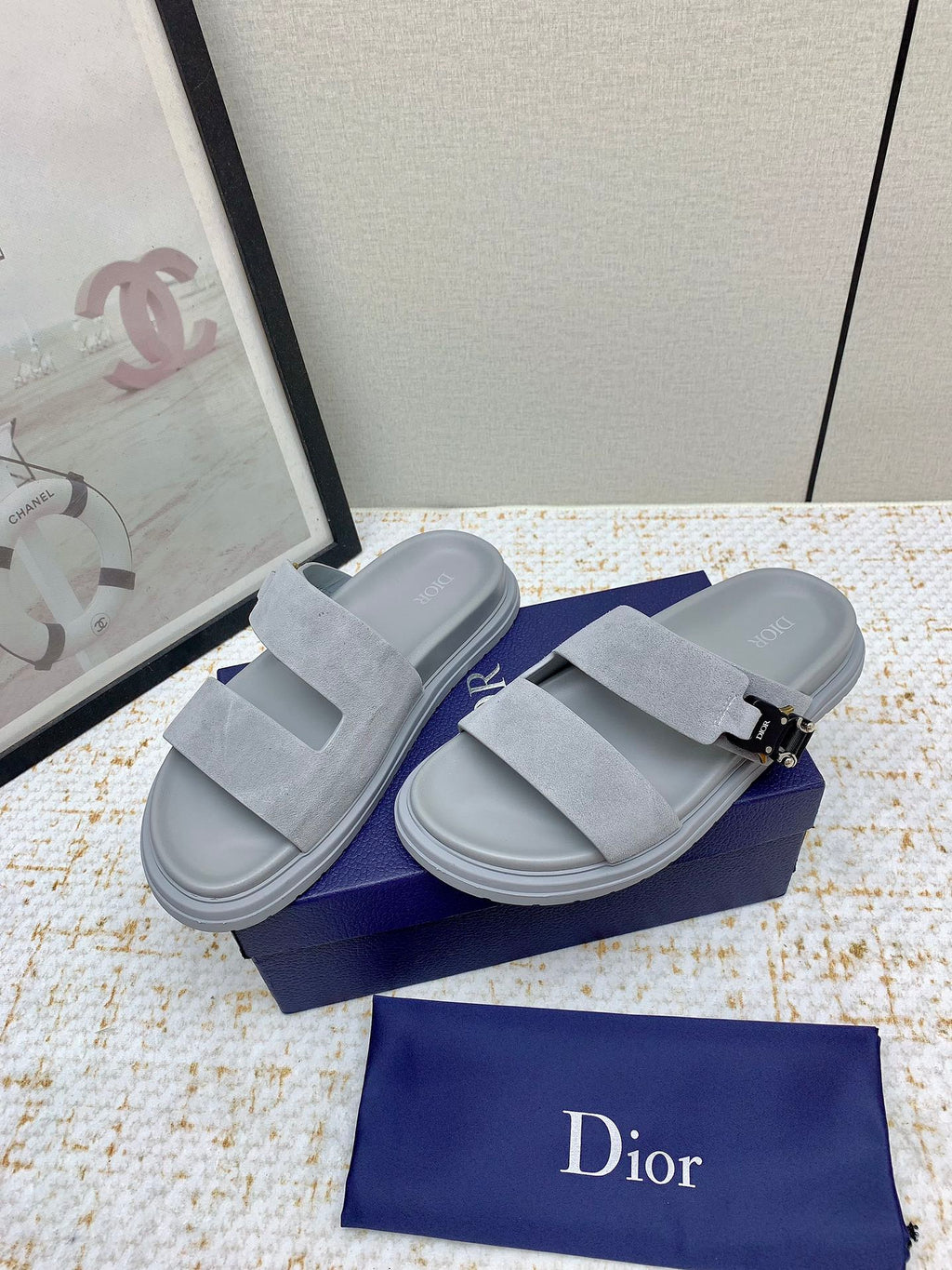 Dior slide sandals in light gray suede, side view with two straps and metal buckle