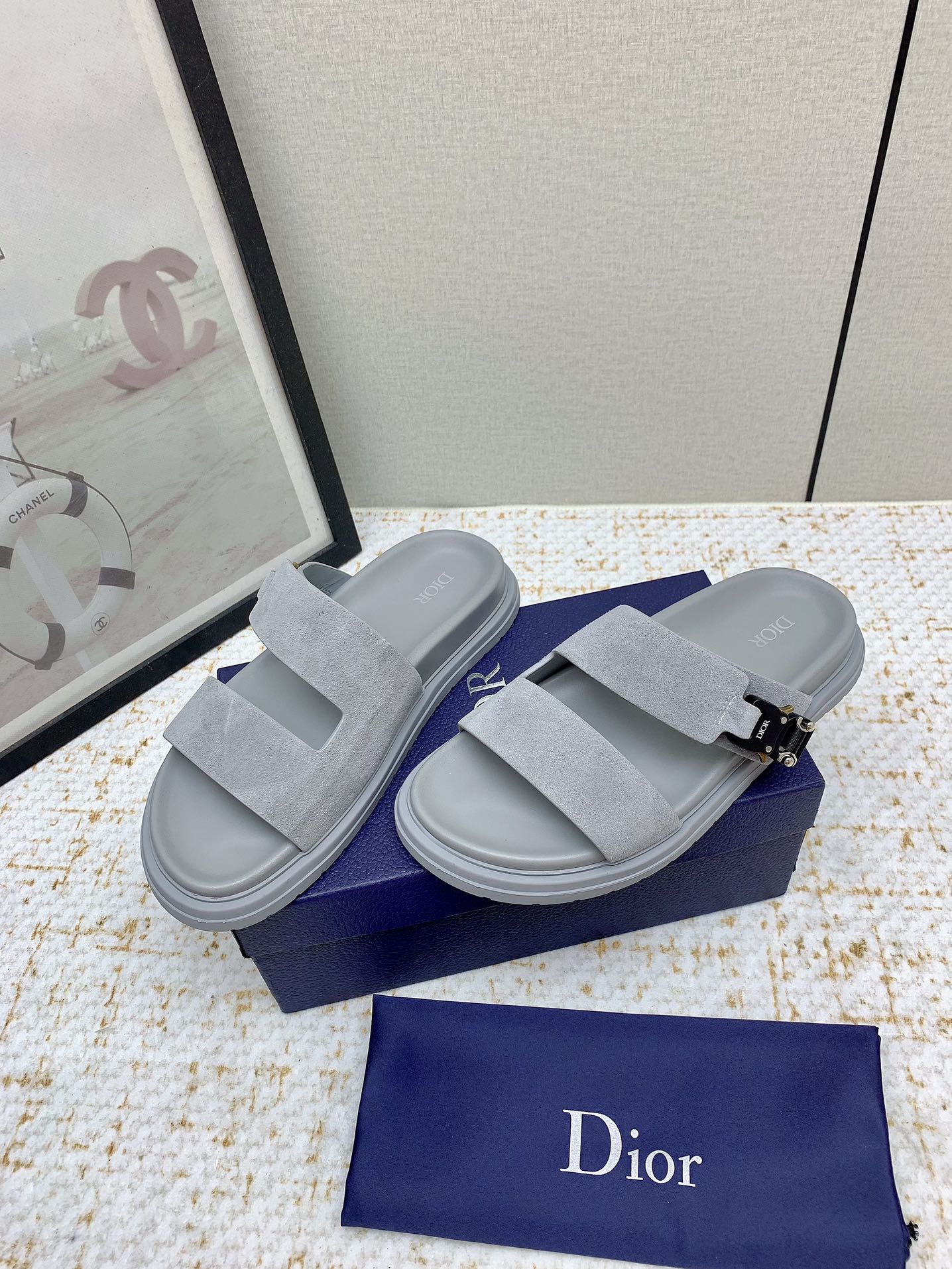 Dior slide sandals in light gray suede, side view with two straps and metal buckle