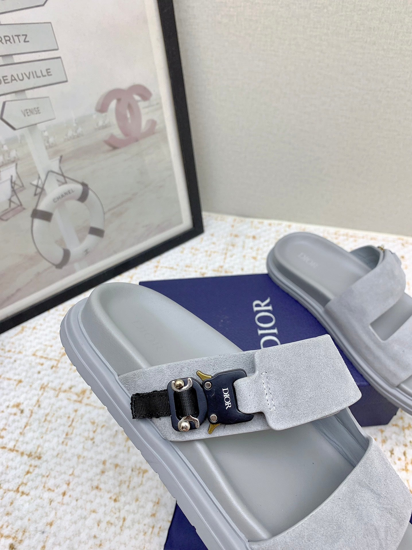 Dior slide sandal in light gray suede with black strap and metal hardware