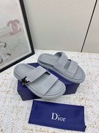 Dior slide sandals in light gray suede with two wide straps and buckle hardware